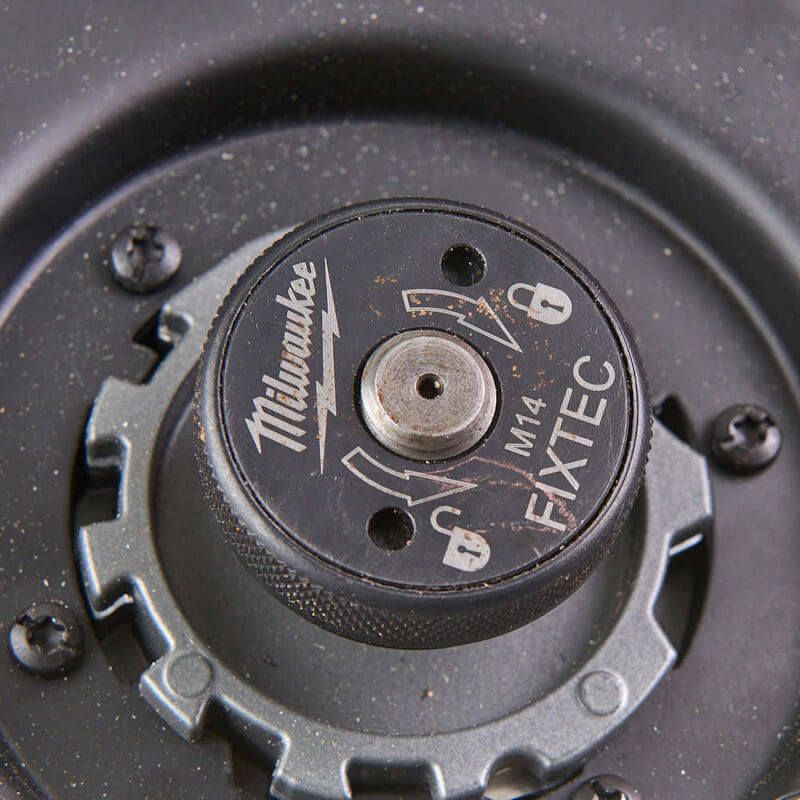 Close-up of Milwaukee M18 FUEL 230mm Braking Grinder showing paddle switch, disc brake, and keyless guard Close-up of Milwaukee M18 FUEL 230mm Braking Grinder showing paddle switch, disc brake, and keyless guard
